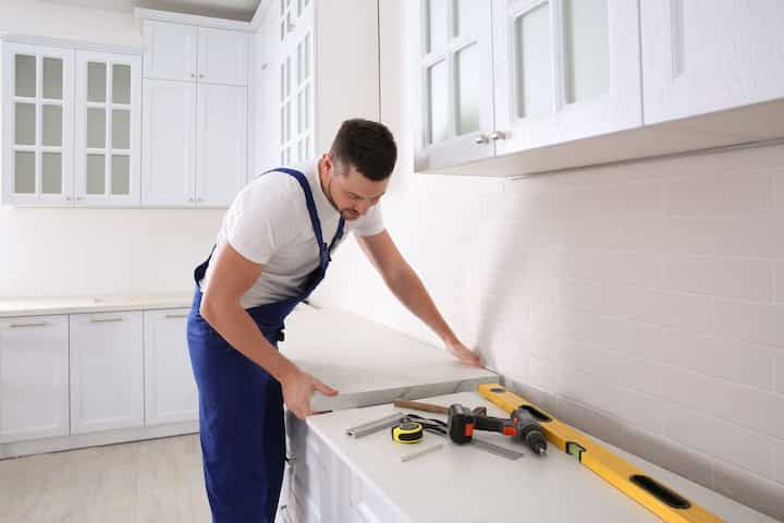 A kitchen remodeling expert installing a countertop in Evesham, New Jersey home